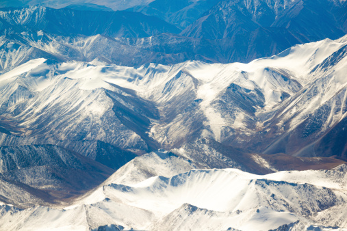 aerial view of mountains and clouds on top