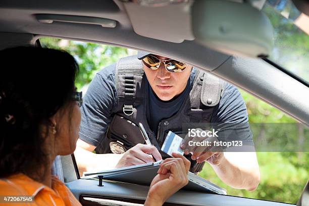 Crime Policeman Gives Driver A Traffic Ticket Stock Photo - Download Image Now - Driver's License, Traffic, Forbidden
