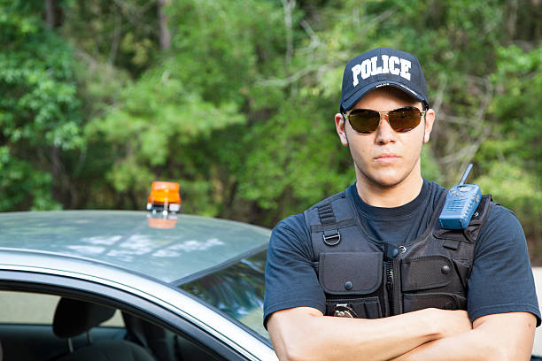 istock Law:  Latin policeman waits by his vehicle. 472067685