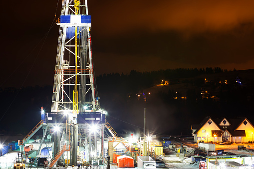 Illuminated Drilling Rig at Night