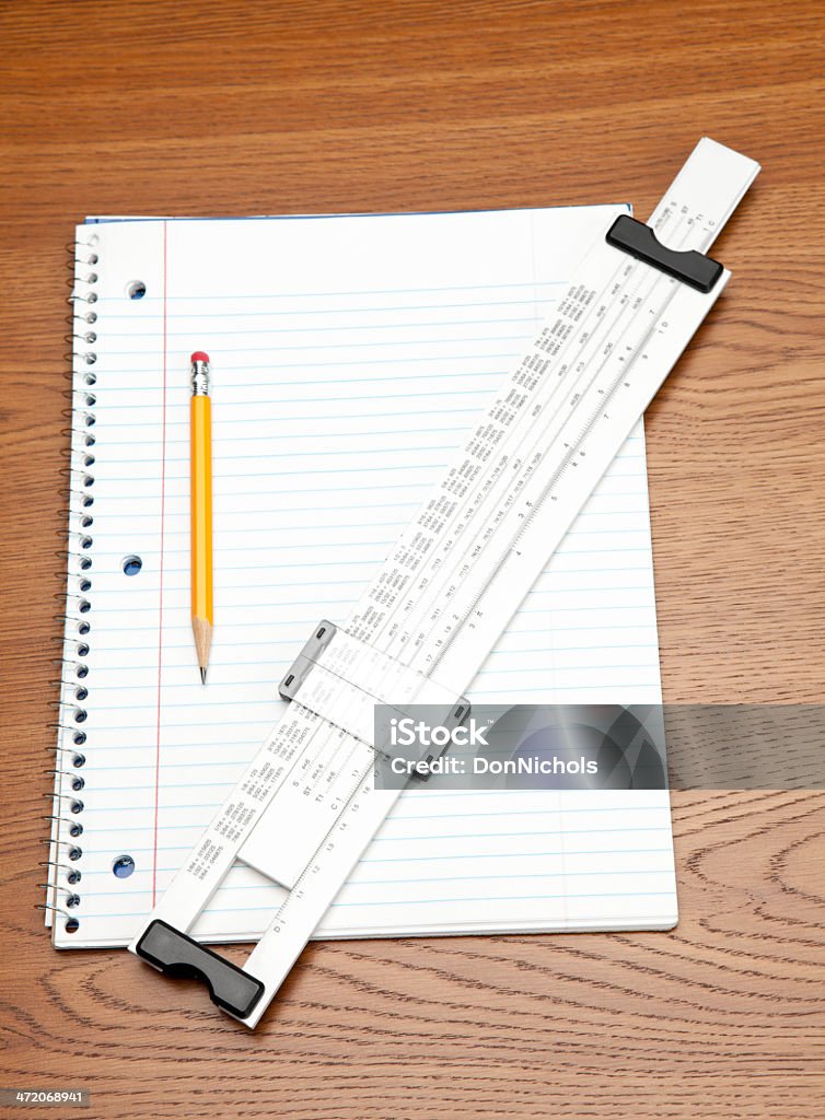 Slide Rule Notebook and Pencil Math the old way, slide rule, notebook, and pencil. Calculator Stock Photo