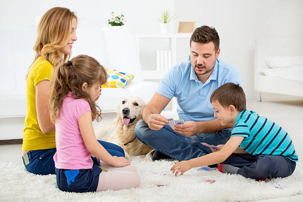 istock Cheerful Family Playing Cards. 472069731