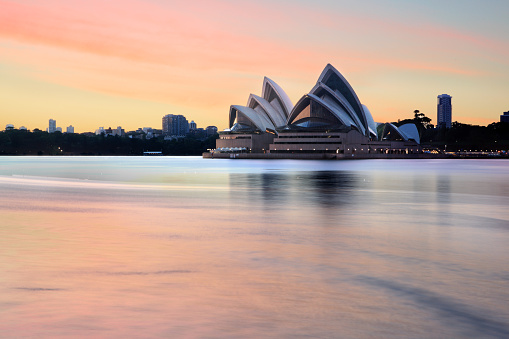 Sydney, Australia - November 28, 2013; Sydney Opera House and Sydney Harbour and foreshore at sunrise, before most harbour traffic stirs the waters.