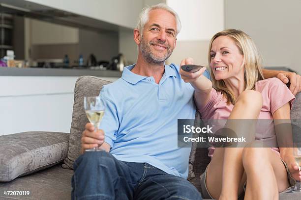 Couple Relaxing With Wine And Watching Tv Stock Photo - Download Image Now - 30-39 Years, 50-59 Years, Adult