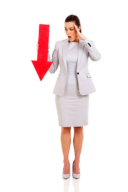 istock young businesswoman holding red arrow 472070480