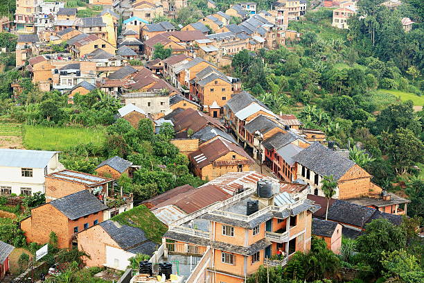 Bandipur, Nepal - October 6, 2012: The locals chat and play in the main street at sunset while some tourists taki photos from a balcony on October 6, 2012 in Bandipur-Tanahu District-Gandaki Zone-Nepal.