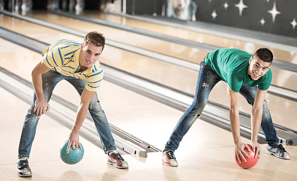 istock Playful men at the bowling alley. 472070853