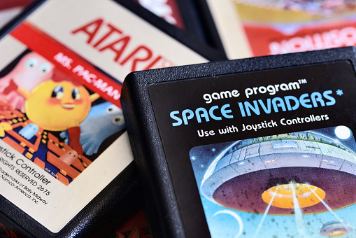 Varallo, Italy - December 6, 2013: Close up photography on vintage Atari 2600 video game cartridges including Space Invaders, Mrs Pac-Man, Pole Position and Kangaroo.
