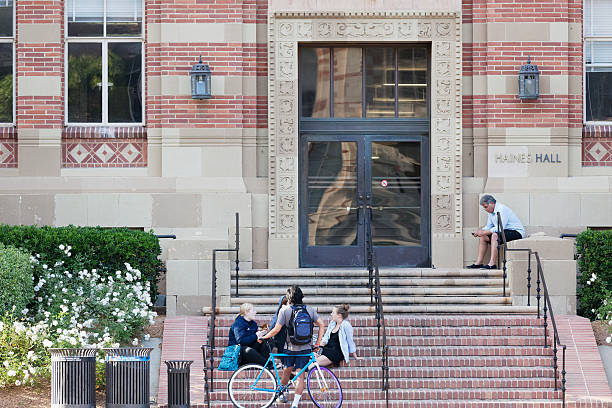 University of California, Los Angeles Los Angeles, California, USA - June 13, 2012. The location is University of California, Los Angeles. Groups of students sitting on the steps on the front of the building. One of the student is resting against a bike. ucla photos stock pictures, royalty-free photos & images