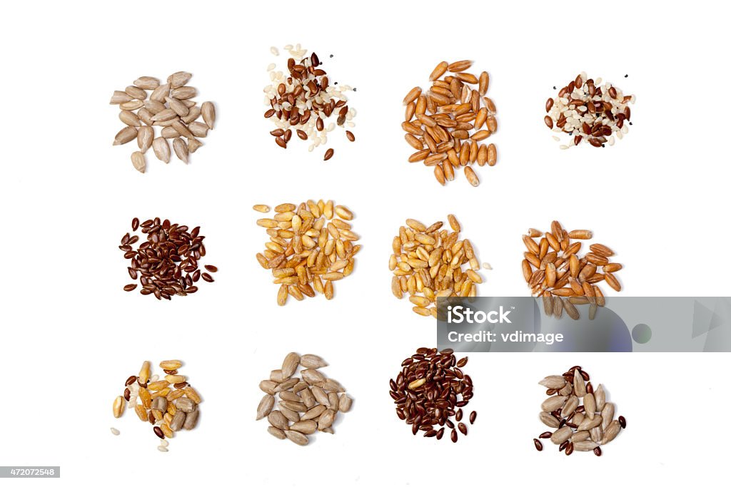 Collection of Cereal Grains and Seeds isolated on white background Collection of Cereal Grains and Seeds -flaxseed; corn; wheat; sunflower seeds; spelled; rye; sesame; oats White Background Stock Photo