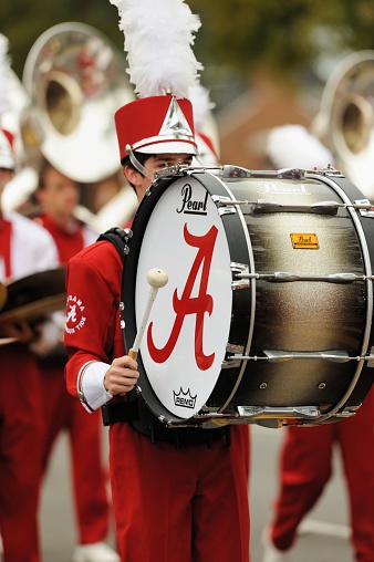Tuscaloosa, Alabama, USA - October 27, 2012: Close up of bass drummer in Crimson Tide Million Dollar Band marching down University Avenue in the 2012 Homecoming Parade at The University of Alabama in Tuscaloosa.