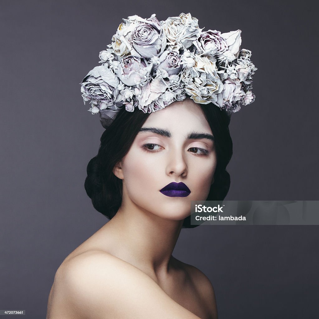 Beautiful woman with wreath of flowers Beautiful woman with wreath of flowers. Professional make-up and hairstyle. High-end retouch. Gothic Style Stock Photo