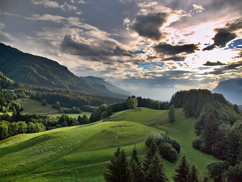 HDR landscape of Carinthian alps with cloudy sunset.