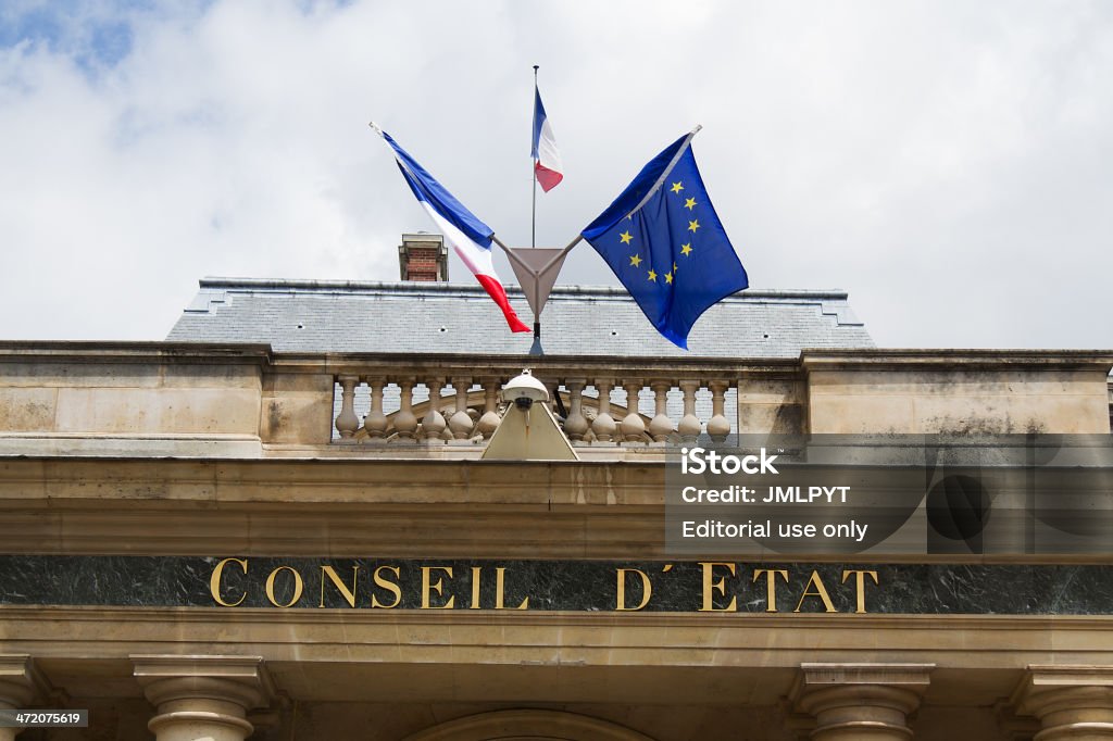 Paris, Monument, Council of State Paris, France - June 6, 2012: Front wall of the Council of State with its French flags and European. The French Council of State is a public institution which sits in the Palais-Royal in Paris since 1875. Courthouse Stock Photo
