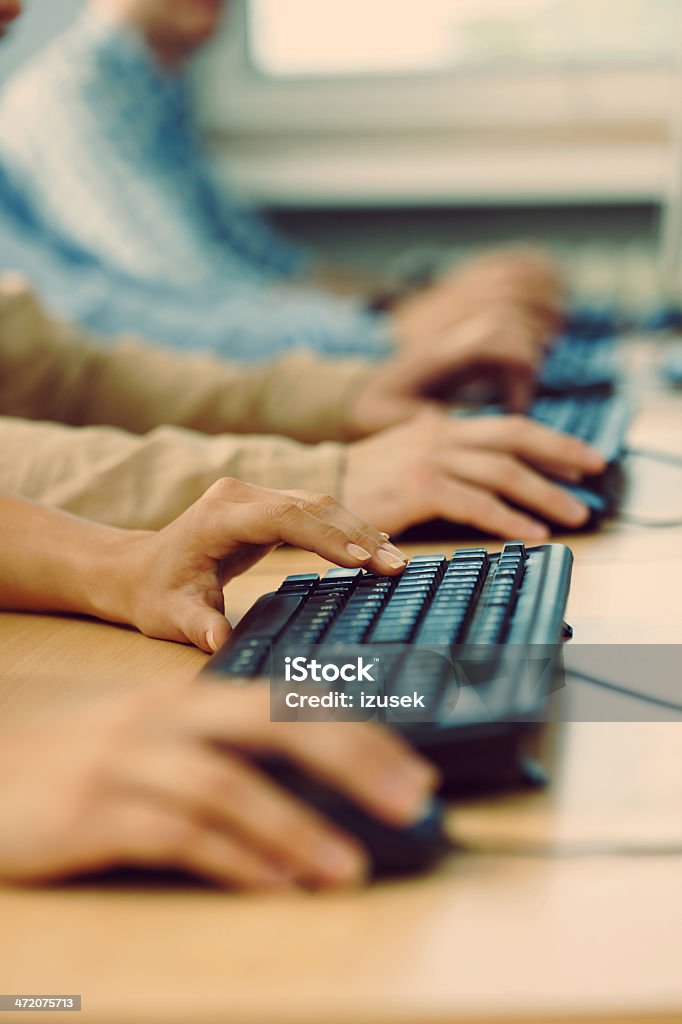 Computer course Focus on human hands and computer keyboards. Internet Cafe Stock Photo
