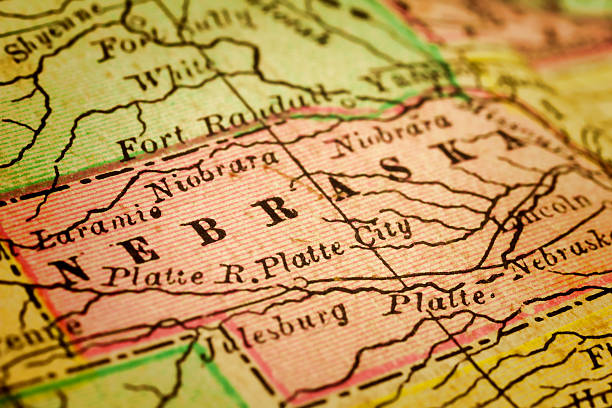 Nebraska State on an Antique map Nebraska on a 1880's map. Nebraska is a state that lies in both the Great Plains and the Midwestern United States. Its state capital is Lincoln. Its largest city is Omaha, which is on the Missouri River. Selective focus and Canon EOS 5D Mark II with MP-E 65mm macro lens. kearney nebraska stock pictures, royalty-free photos & images