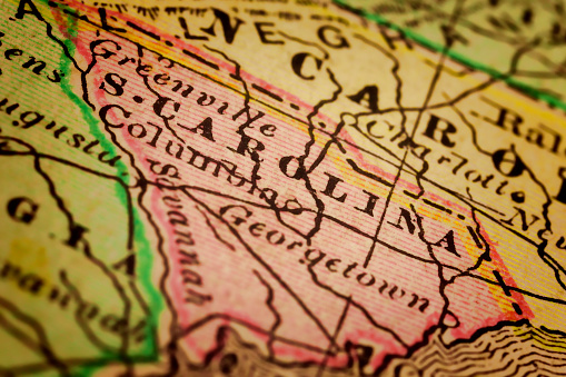 South Carolina on a 1880's map. South Carolina is a state in the Southeastern United States. It is bordered to the north by North Carolina; to the south and west by Georgia, located across the Savannah River; and to the east by the Atlantic Ocean. Selective focus and Canon EOS 5D Mark II with MP-E 65mm macro lens.