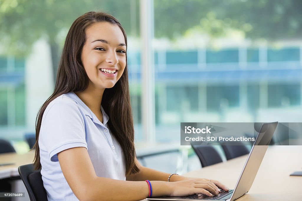 Spanish teen student using laptop in private school classroom Adolescence Stock Photo