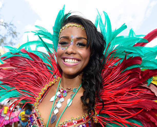 Bridgetown, Barbados - August 5, 2013: Colourful local woman enjoying the Barbados Crop Over festival. This is a traditional harvest festival that had its beginnings on the sugar cane plantations during the islands colonial period.