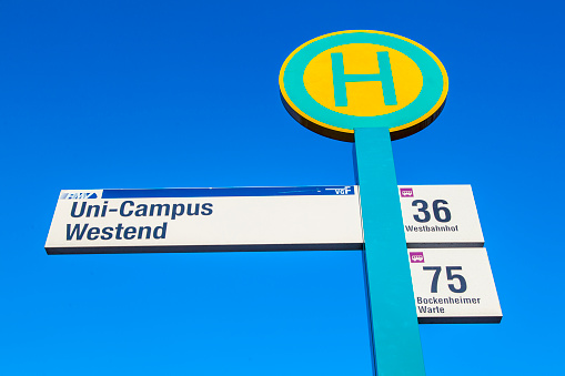 Frankfurt, Germany - September 25, 2011: bus stop sign under blue sky at the University in Frankfurt, Germany. New bus lines were implemented in 2010 to get easy public transportation for the students.