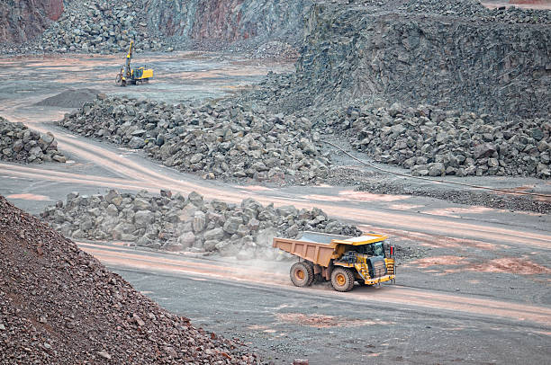 istock dumper truck on road in surface mine quarry 472078633