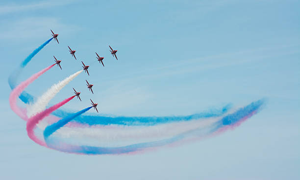 The Red Arrows Colorful Smoke Trail Sunderland, UK - July 27th 2013: The RAF Red Arrows fly in formation at the Sunderland airshow 2013. airshow stock pictures, royalty-free photos & images