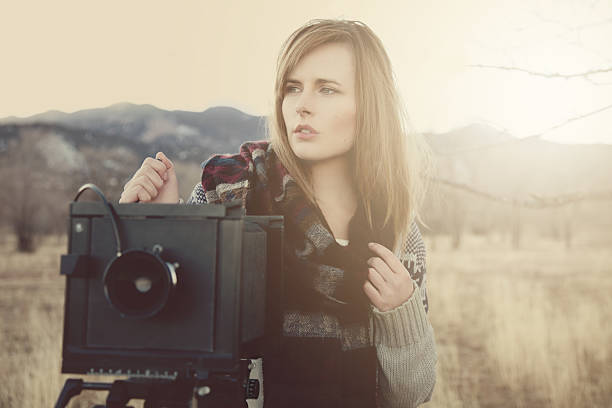 istock Young Woman with Vintage Bellow Camera 472079103