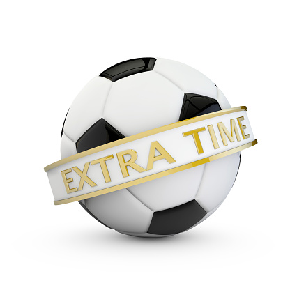 A 3D digital render of a black and white football. The soccer ball is on a plain white background and has a small shadow underneath. Around the ball is a white banner with gold edging. The banner is at a diagonal angle with the word extra time written in gold text.