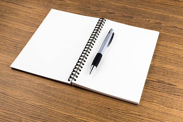 istock notebook and pen on wooden table 472079864