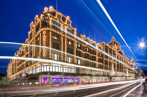 London, the Harrods department stores at night London, United Kingdom - November 01, 2013: The Harrods department stores in London's Knightsbridge at blue hour, with traffic and passengers passing by in blurred motion. harrods photos stock pictures, royalty-free photos & images