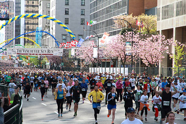 Vancouver Sun Run Starting LIne Vancouver, Canada - April 21, 2013: Runners break from the starting line at the 2013 Vancouver Sun Run in Vancouver, Canada. april 10 stock pictures, royalty-free photos & images