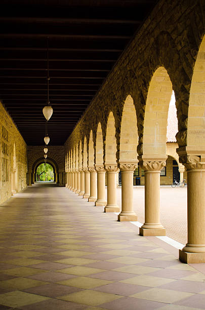 Empty walkway with columns at Stanford University Stanford, United States - October 10, 2011: A walkway with columns is seen during the daytime on the campus of Stanford University. The university was originally established in 1891 and has over 15,000 students.  stanford university photos stock pictures, royalty-free photos & images