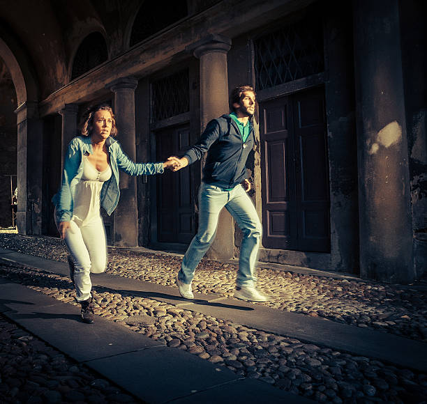 istock couple running scare 472082295
