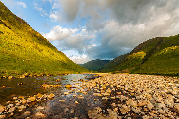 Glen Etive in the highlands of Scotland. A view of the River Etive as it meanders through Glen Etive in the Scottish Highlands.  Image taken at sunrise on a crisp summer morning. etive river photos stock pictures, royalty-free photos & images
