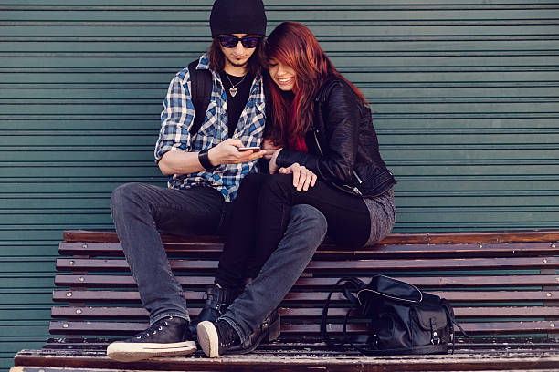 istock Young couple text messaging on smartphone 472082524