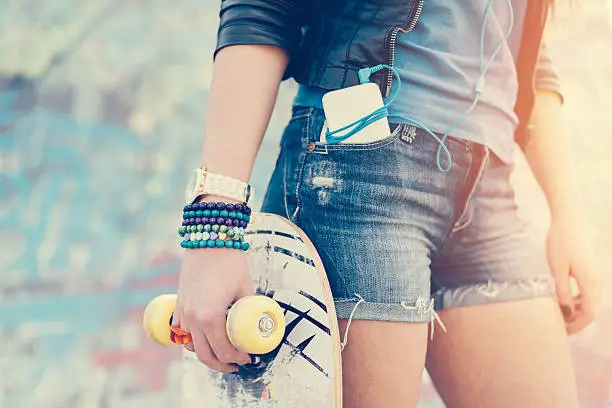 Photo of Teenage girl holding skateboard