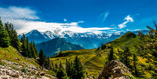 Panorama of the Oeschinen Lake with a frozen waterfall in the Bernese Oberland in the Swiss Alps.