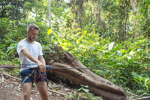 istock Man preparinf zip-line departure 472083202