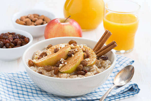 istock oatmeal with apples, raisins and cinnamon for breakfast 472083550