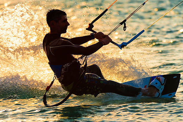 Close-up of a kitesurfer at sunset.