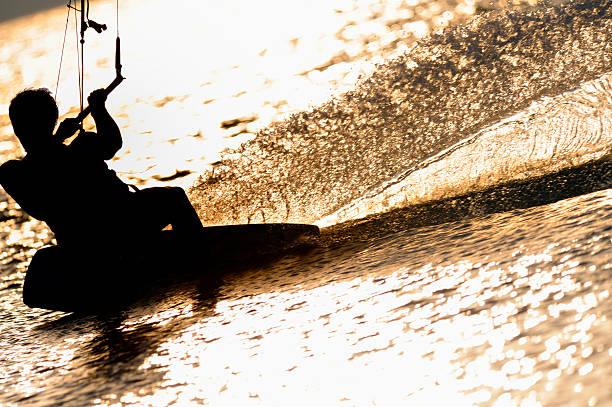 istock Silhouette of a kitesurfer at sunset 472085377