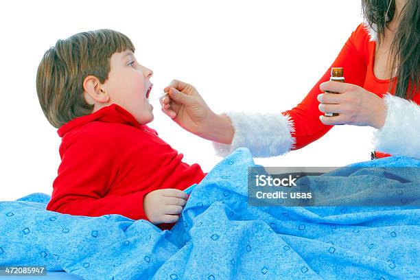 Red Costume Wore Women Giving Syrup To Ill Boy Stock Photo - Download Image Now - 6-7 Years, Adult, Bed - Furniture