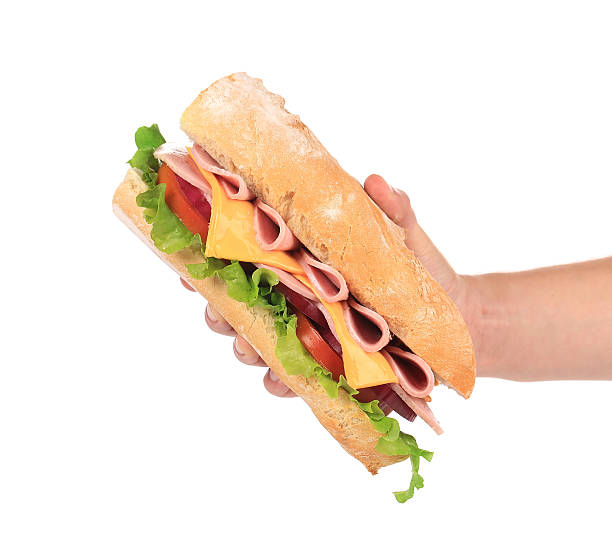 istock French baguette sandwich in hand. 472087641
