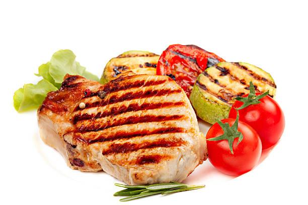 istock Grilled  steak and  vegetables isolated on white background 472088537
