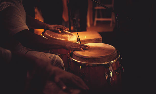 playing congas detail of hands playing latin percussion (tumbadora or congas) percussion instrument stock pictures, royalty-free photos & images