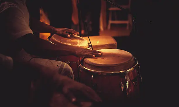 detail of hands playing latin percussion (tumbadora or congas)