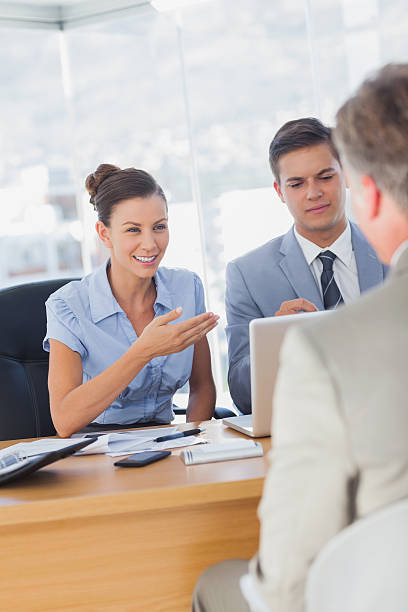 istock Smiling business people interviewing another businessman 472091559
