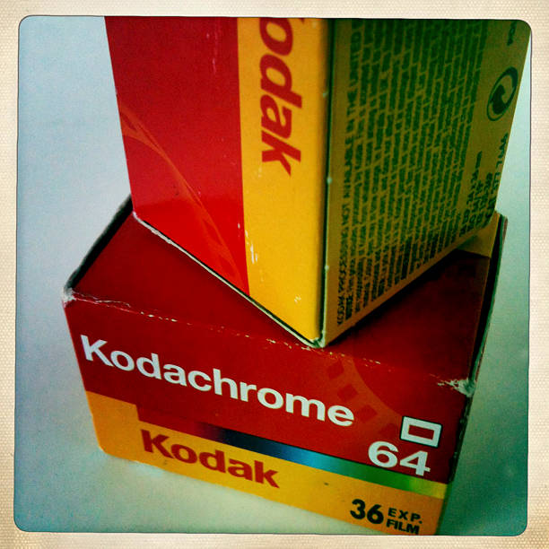 Kendal, UK - November 7, 2012: Two unopened boxes of vintage Kodachrome 64 35 mm colour transparency film. Kodachrome film was introduced in 1935 by Eastman Kodak Company, an American multi-national company founded in 1889 by George Eastman. Photographic film has become more and more marginalised due to the success of digital technology and Kodachrome, one of the iconic film brands of the 20th century, was finally discontinued in 2009.
