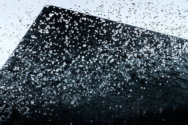 istock Water drops frozen in move, abstraction, black background 472092175