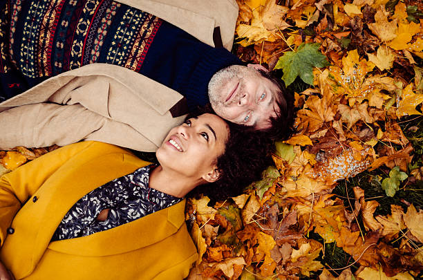 istock Couple Lying Down On Yellow Leaves 472094433